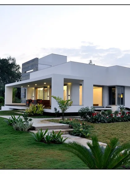 A modern minimalist home deserves a landscape to match. We used a simple design with a healthy green lawn, low-maintenance plants, and a clean stone path to complement the house's architecture.
