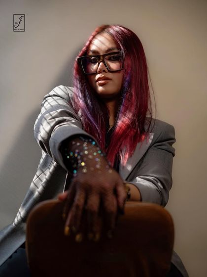 A creative portrait using shadows from window blinds to create a pattern of light across the model. The glittery glove adds a touch of glamour.