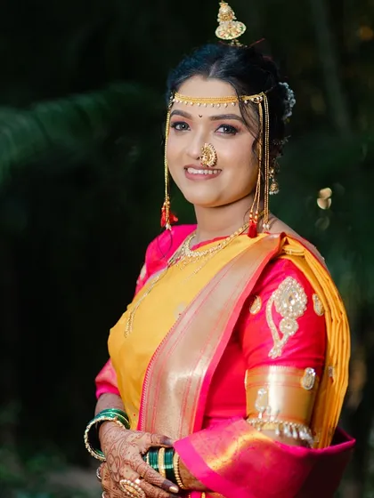 A beautiful portrait of the bride, highlighting her traditional jewelry and radiant smile.