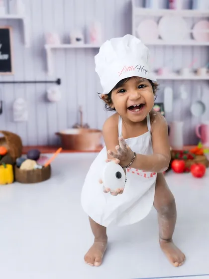 "Look what I made!" This little chef is so excited to show off her floury hands.