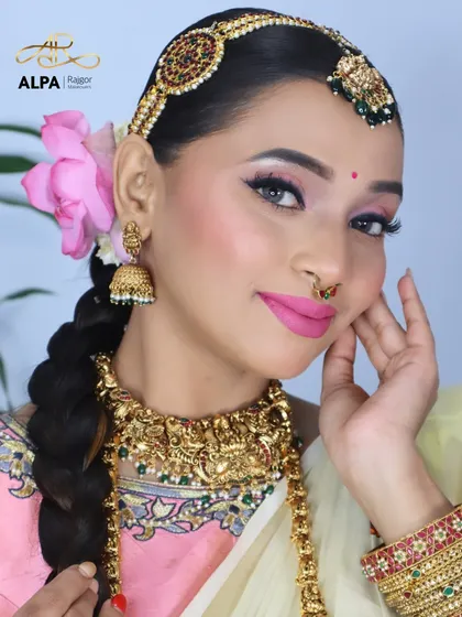 A modern take on a classic South Indian look. I've paired a bright pink lip with soft, defined eyes and traditional gold temple jewelry for a fresh and elegant party-ready appearance.