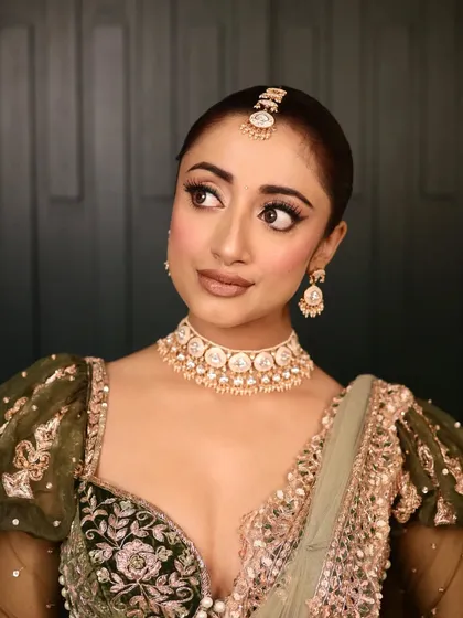 A close-up of the makeup for this bridal look. I created a sharp, winged liner and a soft, neutral lip to balance the intricate details of her outfit and jewelry.