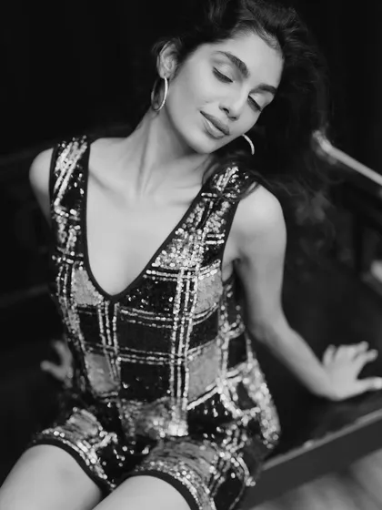 Another take from the same black and white series. This image showcases how the makeup interacts with soft, expressive posing, ensuring the model's features remain defined and photogenic from every angle.