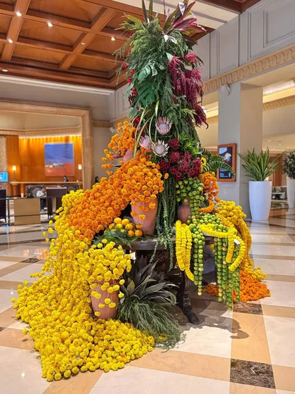 Another beautiful angle of the lobby centerpiece, capturing the vibrant colors and the feeling of festive abundance. This type of installation transforms a public space into a memorable experience.