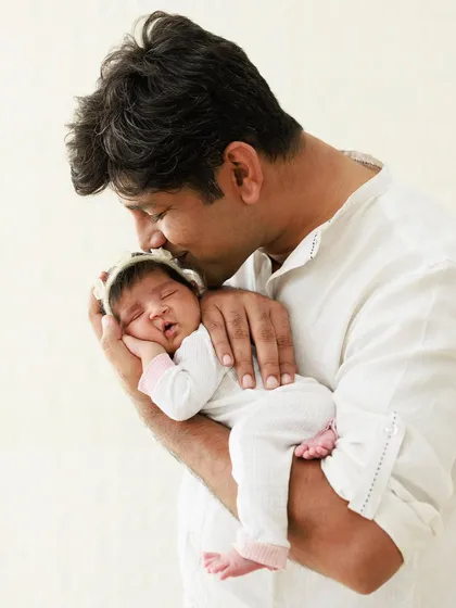 A father's gentle kiss on his newborn's head. These quiet, tender moments are what make father and child portraits so incredibly special and timeless.