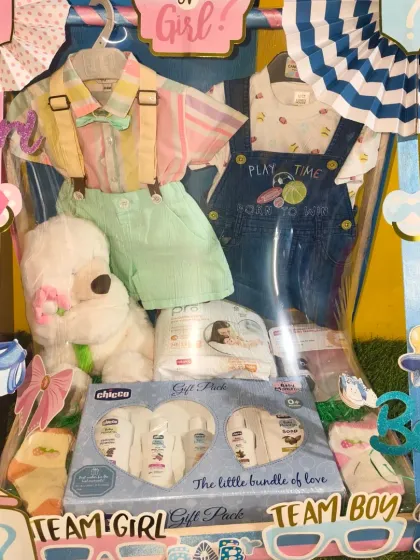 The 'Team Girl' and 'Team Boy' decorations on this baby shower hamper make it a perfect centerpiece for the event.