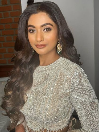 A different angle showing how the makeup enhances her features, creating a sculpted and radiant look that is perfect for an evening event.