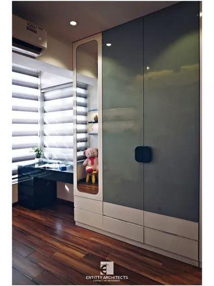 Functionality is built right in. This view shows the custom wardrobe with an integrated study desk and open shelving, making smart use of the space next to the window for natural light.