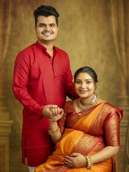 A classic, happy portrait of the parents-to-be. Your bright smiles and connected hands show the joy and partnership you share on this incredible journey.