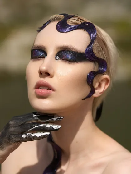 This is my 'Siren of the Sea' concept, where I combined a dark, glittery smokey eye with a sculpted, wave-like hair doodle. It's a great example of how I blend makeup and hair artistry.