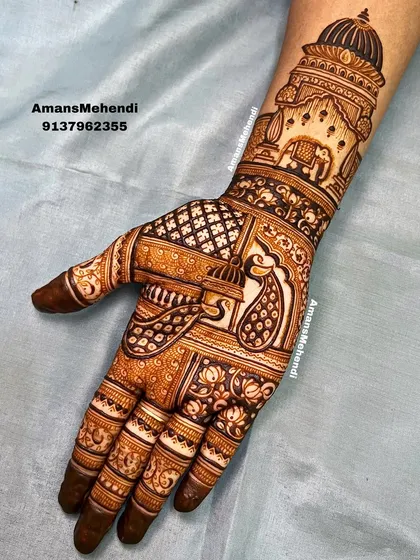 A majestic design featuring a grand palace dome on the wrist. The palm is adorned with a beautiful peacock and an elephant, classic symbols of royalty and grace in bridal mehndi.