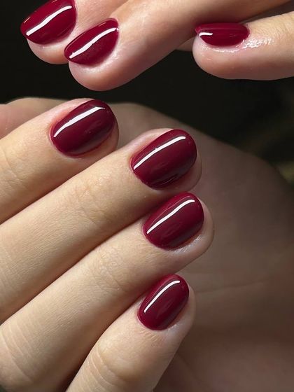 A deep, rich burgundy polish applied with perfect precision. This color is a classic choice for a sophisticated and powerful look.