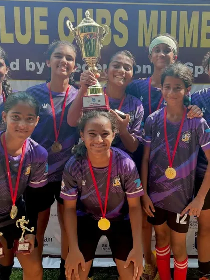 Our U15 girls team celebrating with the trophy after winning the Blue Cubs Mumbai 2024 tournament.