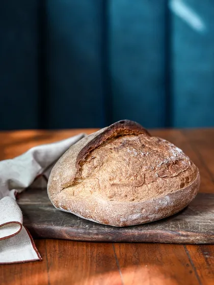 Our classic sourdough loaf, sitting pretty. Baked fresh daily, it has a wonderfully tangy flavor, a chewy, open crumb, and that perfect crust. It’s the foundation for our sandwiches and toasts, and you can take a loaf home from our deli.