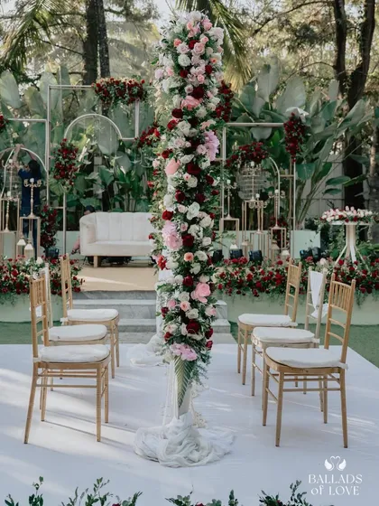 A stunning floral arrangement at a Nikah ceremony. The tall pillar of red and white roses makes a dramatic and beautiful statement on the main stage.