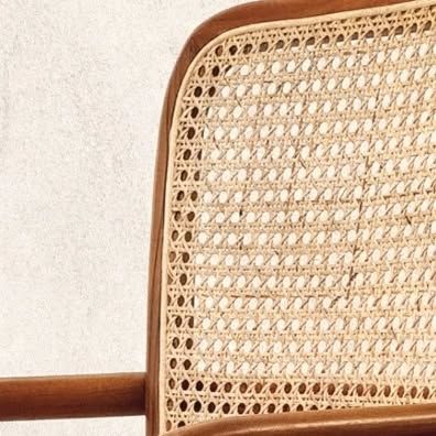 A close-up of the hand-woven rattan back of one of my chairs. This same dedication to natural materials and meticulous craftsmanship is present in every piece I create, whether it's a chair or a lamp.
