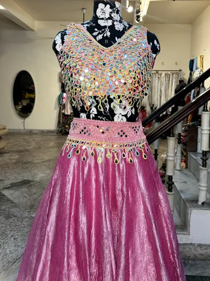 The detailed belt adds a modern touch to the lehenga and helps define the waist.