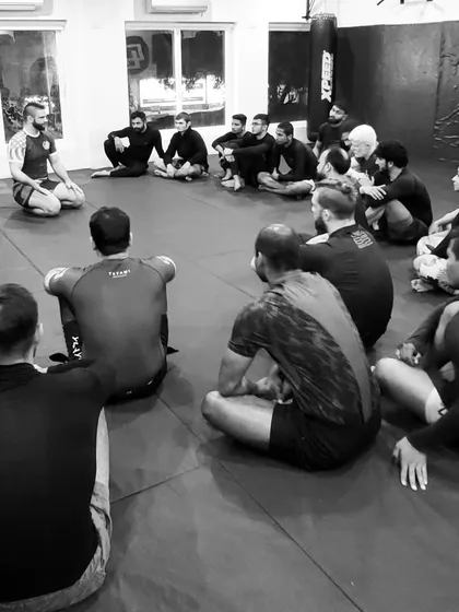 A coach addresses the class. These moments of instruction and reflection are just as important as the physical training. We are always learning together.