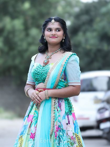 My flora and fauna lehenga is perfect for celebrating youthful grace. The vibrant, printed skirt is paired with a textured green blouse and a light blue net dupatta, creating a fresh and lively look for my teenage client Honisha.
