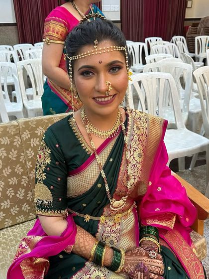 This bride is all smiles, ready for her Peshwai wedding. The makeup is flawless, ensuring she looks perfect from every angle.