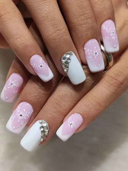 This elegant French manicure on square nails features a soft pink ombre base with delicate, hand-painted white floral details and rhinestone accents for a touch of sparkle.