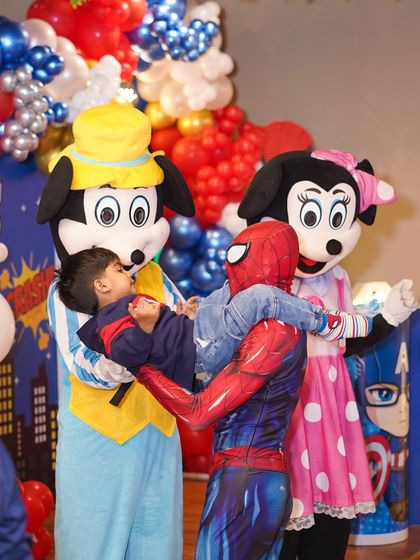 A heartwarming moment between mascots and a young guest at a Marvel-themed party. We create a friendly and interactive atmosphere where kids can meet their heroes.