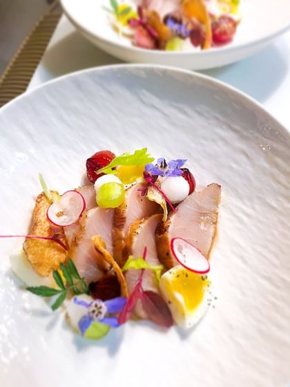 A delicate preparation of Kanpachi, or Amberjack. The fish is served with yuzu, miso, a soft quail egg, and crispy taro chips for texture.