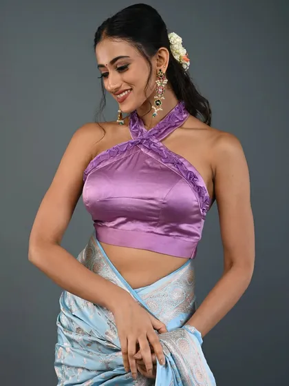 My collection also includes chic, modern designs like this satin halter-neck blouse in a lovely lavender shade. It's a versatile piece that can be worn with a saree for a contemporary ethnic look or paired with a skirt or jeans as a stylish crop top.