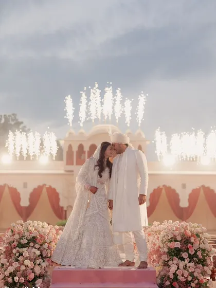 As the couple shares a kiss, the custom pyrotechnics I arranged go off, creating a magical, sparkling halo above them. It's these moments of planned magic that make a wedding unforgettable.