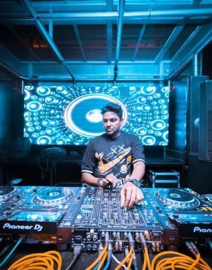 In the zone at Kitty Ko, surrounded by the signature blue lighting. My focus is always on the music and the energy of the people in front of me.