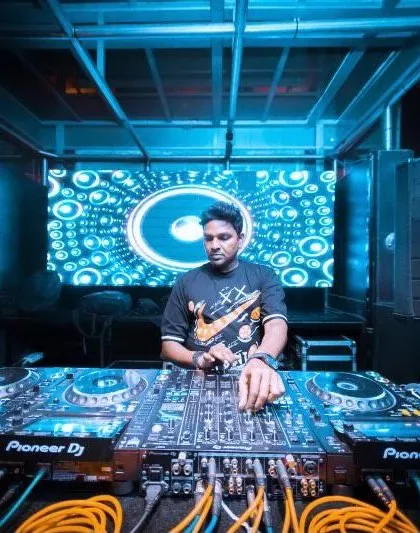 In the zone at Kitty Ko, surrounded by the signature blue lighting. My focus is always on the music and the energy of the people in front of me.