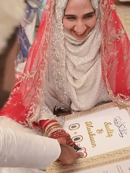 A moment of pure joy as the bride and groom sign their Nikahnama. Her smile says it all. This candid shot captures the happiness of officially becoming husband and wife.
