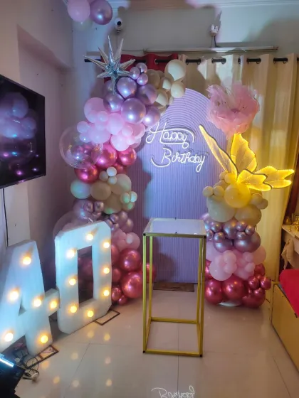 We created this butterfly-themed 40th birthday decoration in a compact home space. The setup includes an arched backdrop, a 'Happy Birthday' neon sign, light-up butterfly props, and '40' marquee numbers, showing how we can create a big impact in any room.