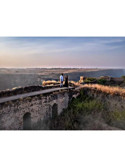 A couple shares a quiet moment on an old stone bridge during their pre-wedding shoot. Using the drone allows me to capture both the intimacy and the epic scale of the landscape.