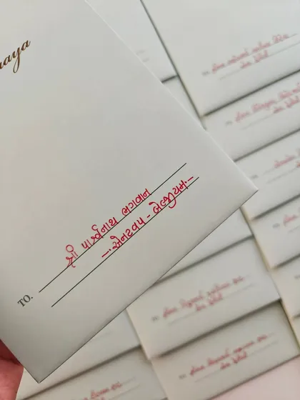 There is a special peace that comes from writing in my mother tongue. This is a close-up of envelope addressing in Gujarati, a service that feels like coming home and adds a deeply personal, traditional touch to your invitations.