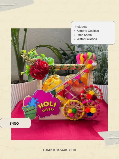 This decorated Wooden Cart Holi Hamper is another great option at ₹450. It's filled with almond cookies, paan shots, and water balloons for a sweet and fun celebration.