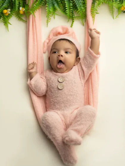 A playful moment with a tongue out, showing this baby's fun personality even at such a young age.