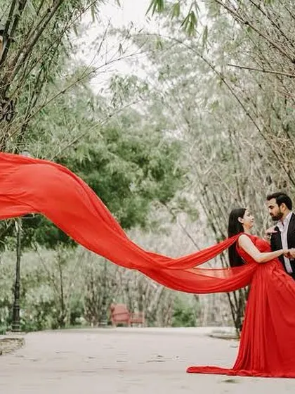Create your own movie moment with our pre-wedding photoshoot gowns. This dramatic red gown with a long, flowing trail is designed to make a statement and give you breathtaking photos you'll cherish forever.