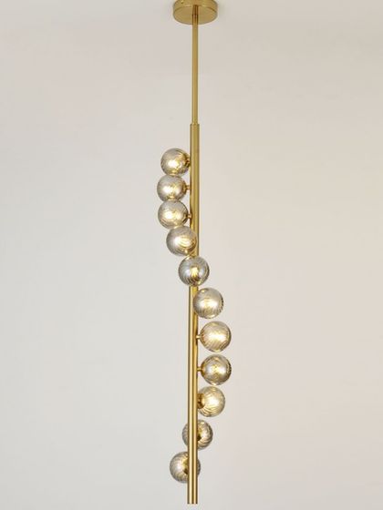 A spiral pendant with smoked glass globes, perfect for a staircase or a room with a high ceiling. The design draws the eye upward.