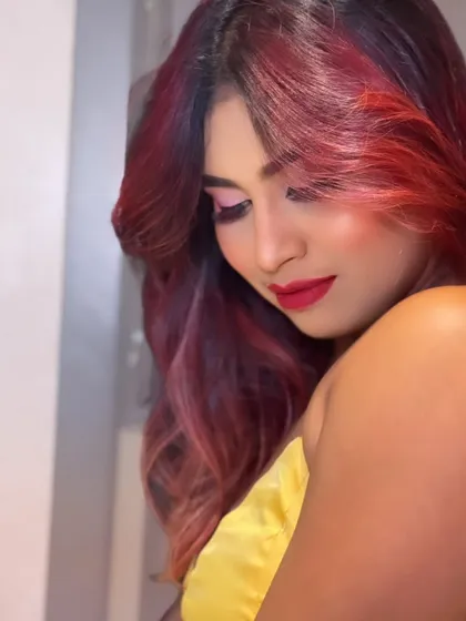 A beautiful shot capturing the complete party look with her vibrant red hair. The makeup is designed to complement her unique style.