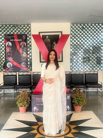 Posing by the TEDx display after my talk. My goal is to help youth understand that while social media can be an asset, it's crucial to control our devices to control our minds.