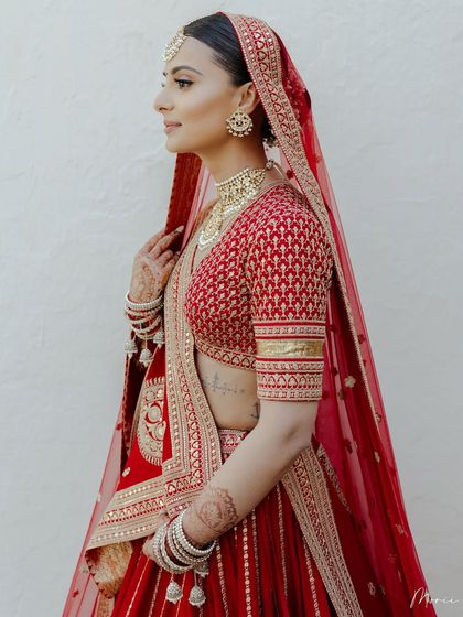 This image captures the timeless elegance of a bride in a classic red lehenga. You'll learn to create these iconic looks that never go out of style.