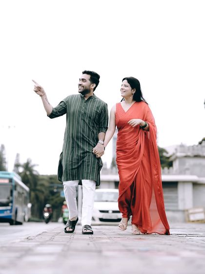 A candid shot of a couple in ethnic wear walking down a Bangalore street, capturing a slice of city life.