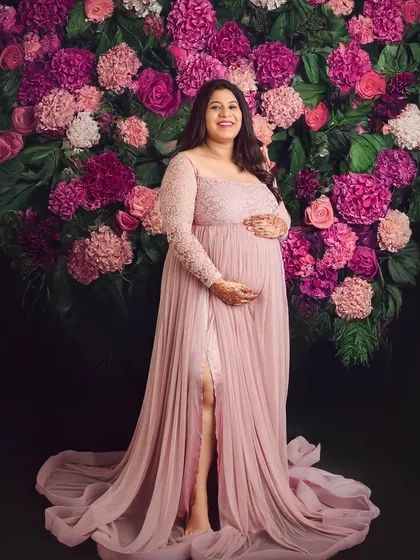 Our floral wall is a favorite for a reason. Here, the mom-to-be glows in a beautiful dusty rose gown, creating a portrait that is both vibrant and incredibly elegant.