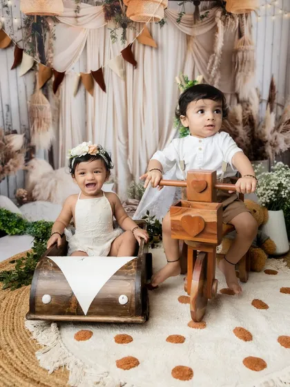 All aboard! A fun shot of the siblings playing with the wooden train and car props.