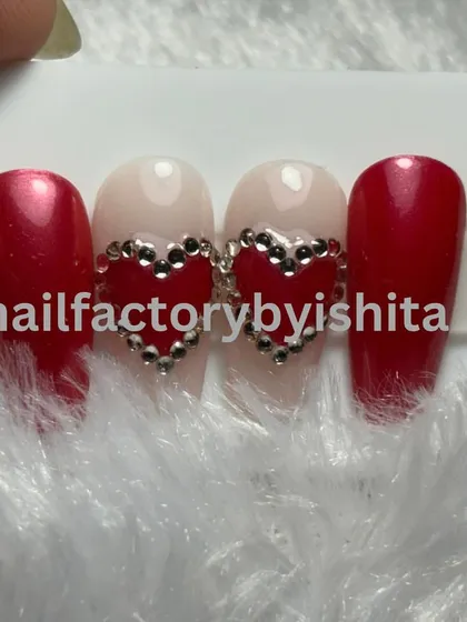 A cute red and nude press-on set with rhinestone heart details, perfect for Valentine's Day or any romantic occasion.