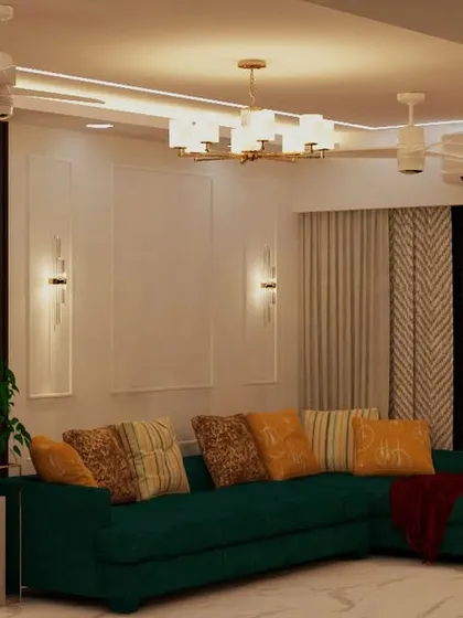 Another view of the living room with the green sectional sofa, highlighting the elegant wall molding and sconces.