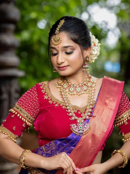 A close-up of the bride's beautiful makeup and jewelry, with the textured pillar in the background.