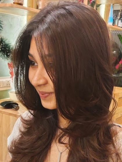 A close-up of the soft layers and face-framing pieces of this beautiful haircut.