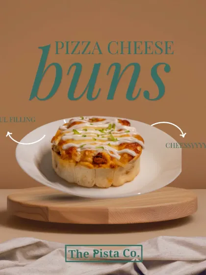 Introducing our Pizza Cheese Buns, the perfect savory snack. This image shows a single, fluffy bun on a clean white plate, topped with melted cheese and a sprinkle of herbs, promising a soul-filling and cheesy bite every time.